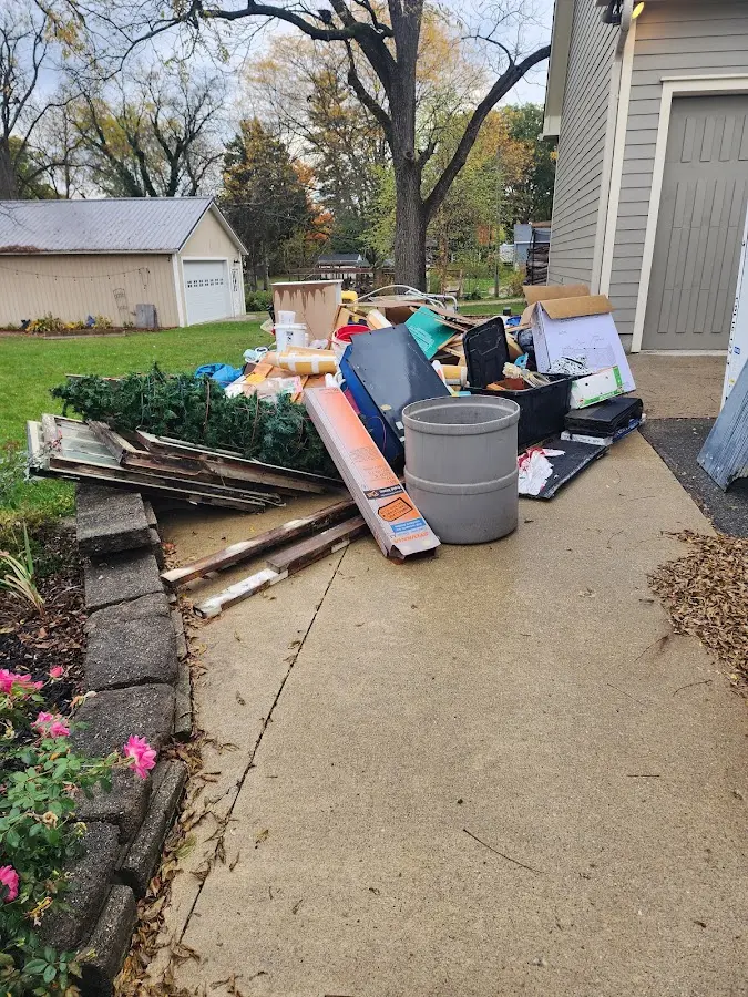 Dumpster being loaded with debris for 10 Yard Dumpster Rental in Poolesville